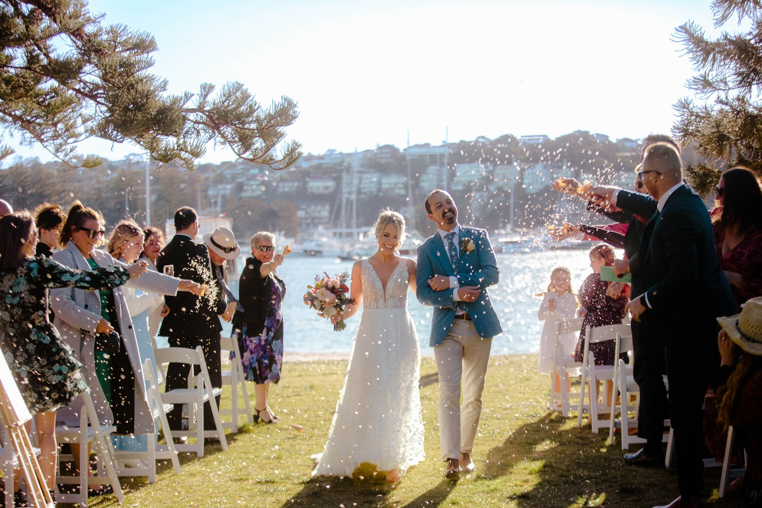 The happy couple are just married following a beautiful wedding ceremony on the beach at Clontarf, Northern Beaches.